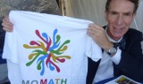 Bill Nye showing off a MoMath T-shirt (available at momath.org/shop).