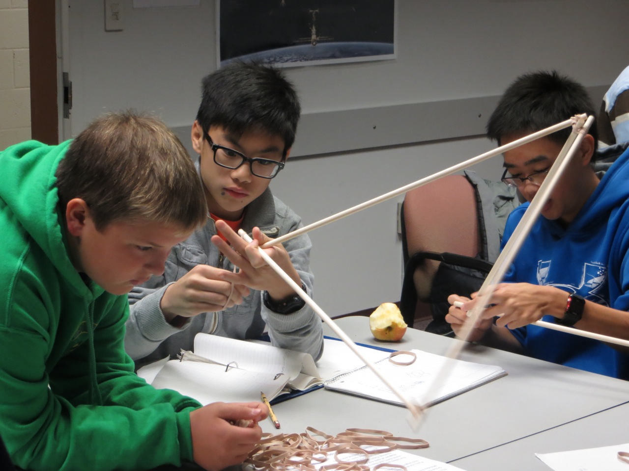 Three boys working on math activity