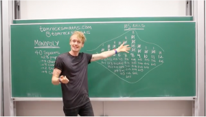 Man in front of green chalkboard