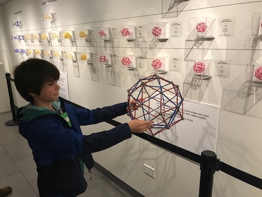 Boy holding polyhedra