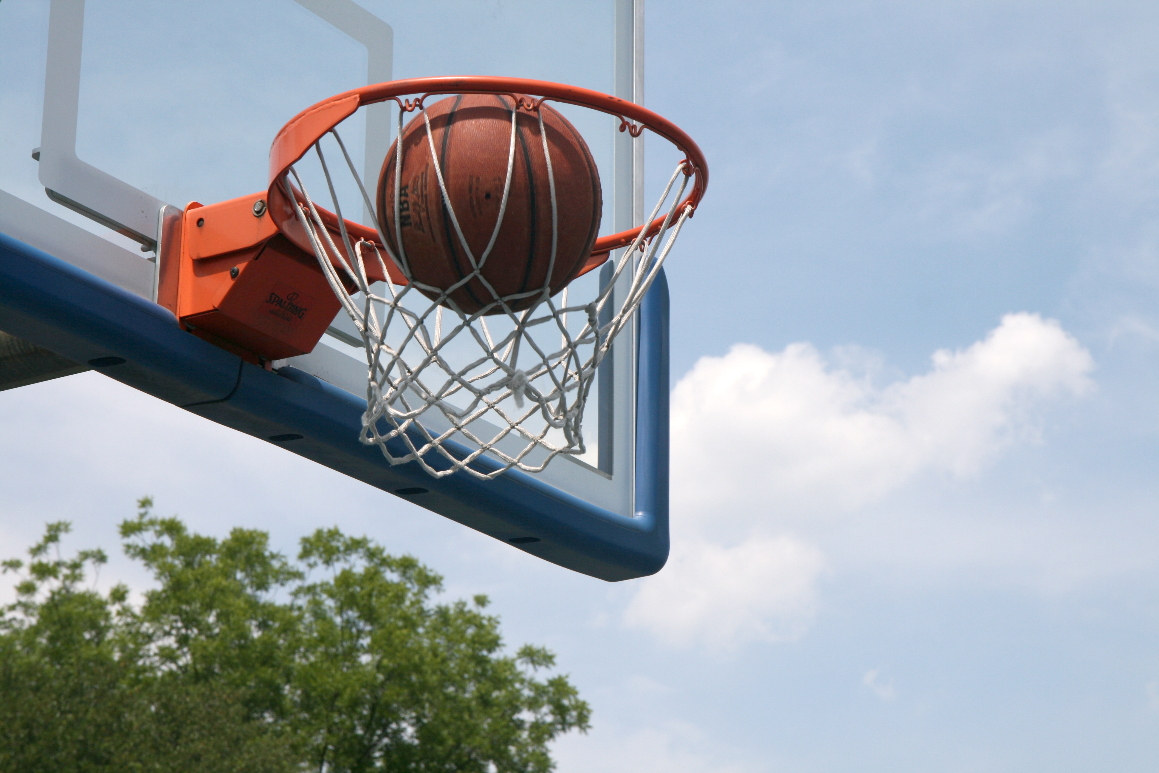 Basketball in basketball hoop.