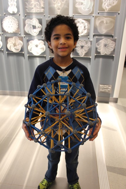 Front view of boy holding polyhedron